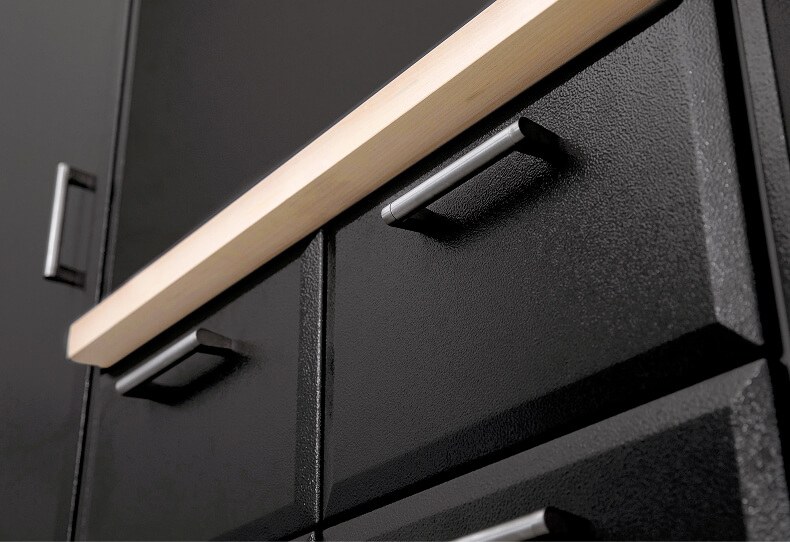 Close-up of powder-coated cabinet fronts with a maple top